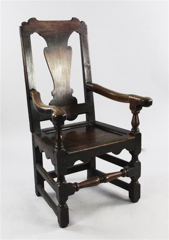 An 18th century oak open armchair,